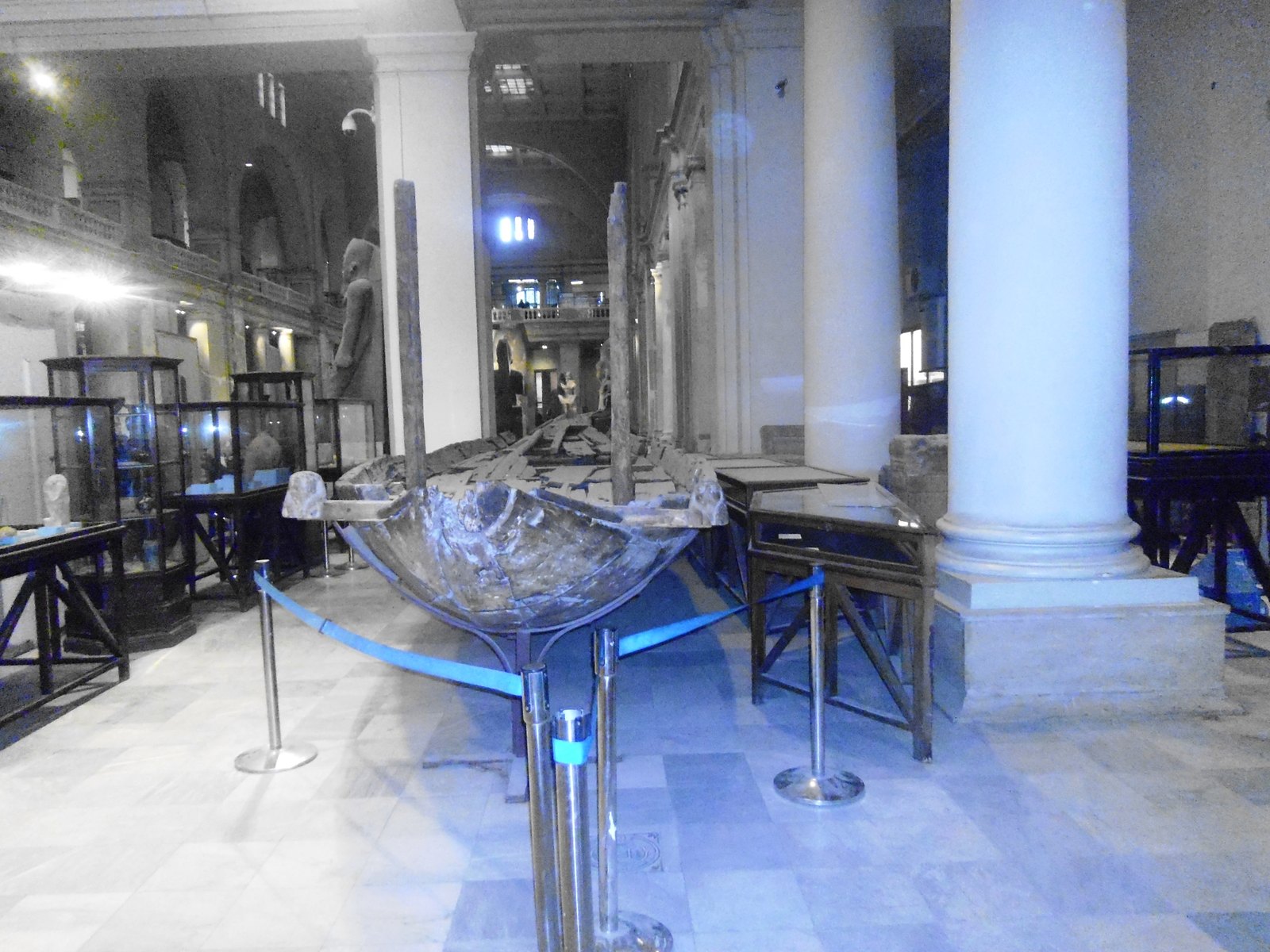 Interior gallery of the Egyptian Museum in Cairo with display cases and sculpture